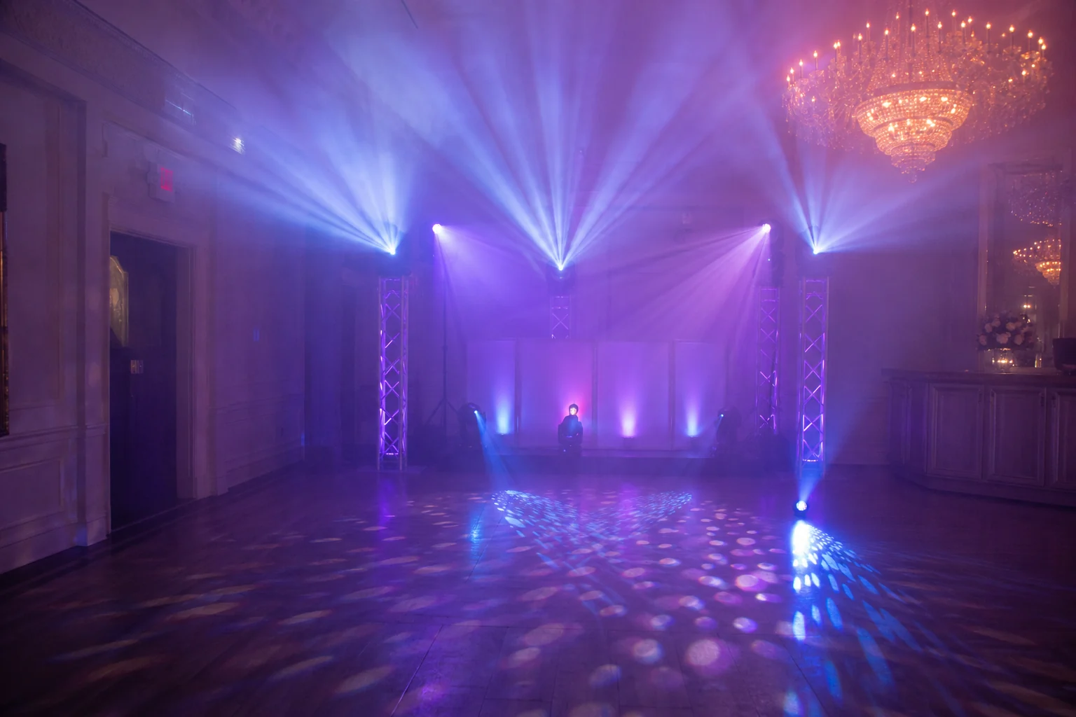 Purple and blue dance-floor lighting made visible with a professional haze machine